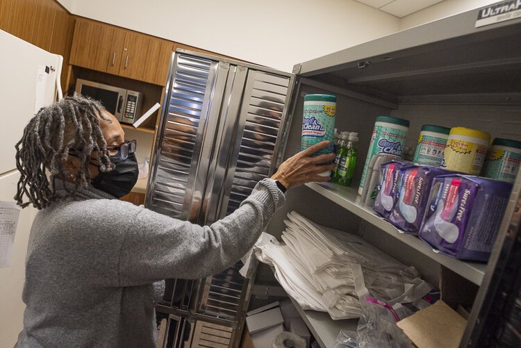 MyCom Coordinator, Benda Pryor stocks the shelves at the Cuyahoga County Public Library, Garfield Heights Branch closet