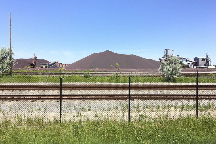 Mountains of taconite pellets carve a majestic line against the horizon at the Cleveland Bulk Terminal.