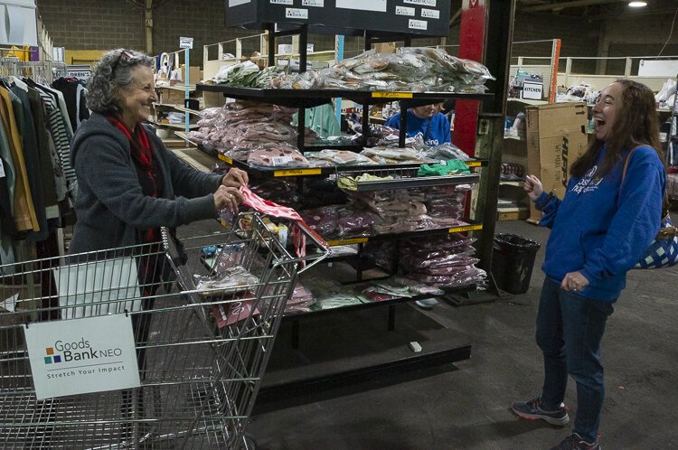 Judy Payne showing some new goods to Corie Friedman from Fostering Hope