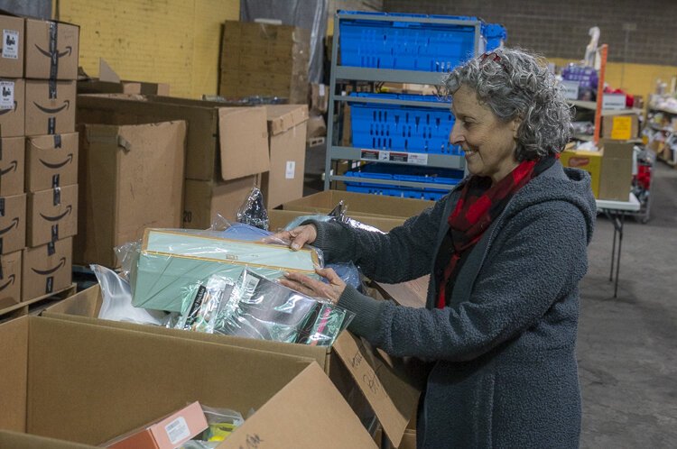 Goods Bank NEO Founder Judy Payne sorts through new good coming into the Bank