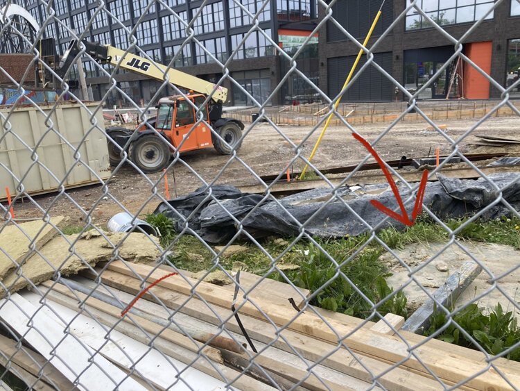 The arrow shows the location where the orb sculpture stood during the Into building construction