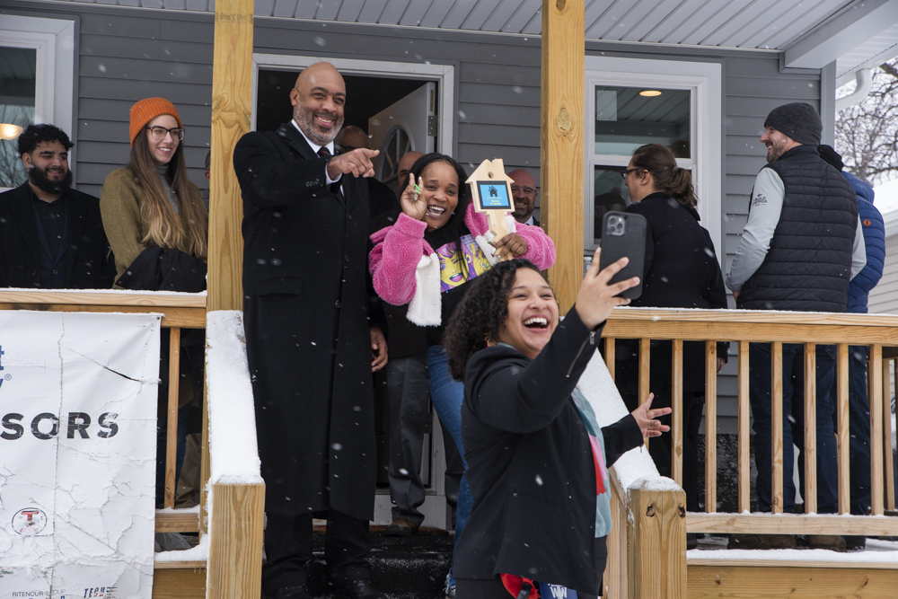 Blaine Griffin (right) poses for a selfie with Sierra and Alyssa Hernandez at the Habitat for Humanity Home Dedication Ceremony on Grandview Ave