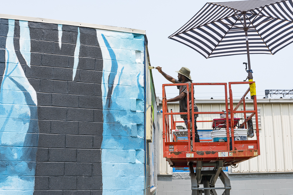 Isaiah Williams painting his Emerald Necklace mural