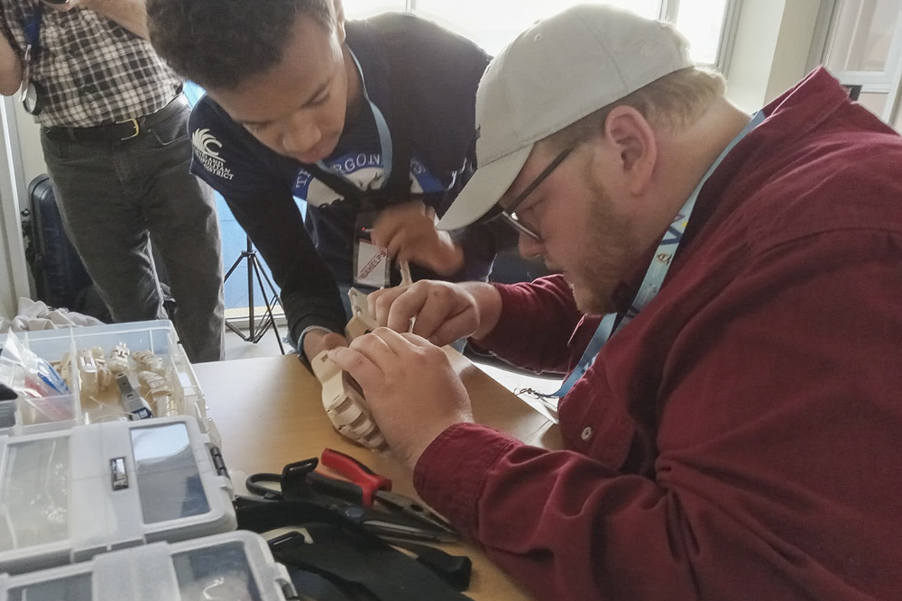 IMAHelps volunteers working on a 3D printed prostetic