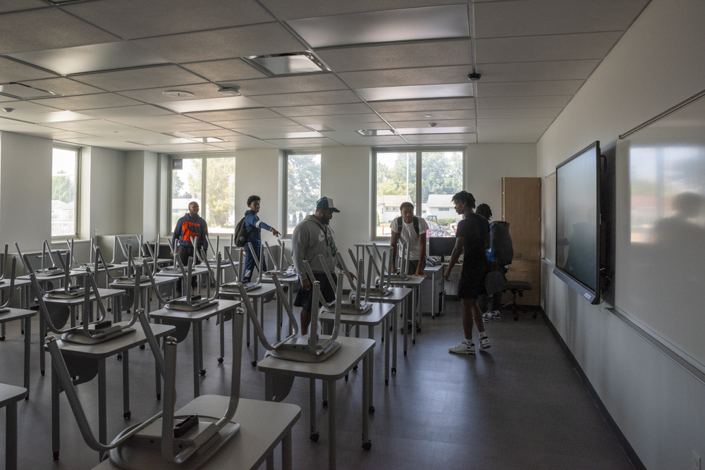 Classrooms with floor to ceiling windows surround each learning area