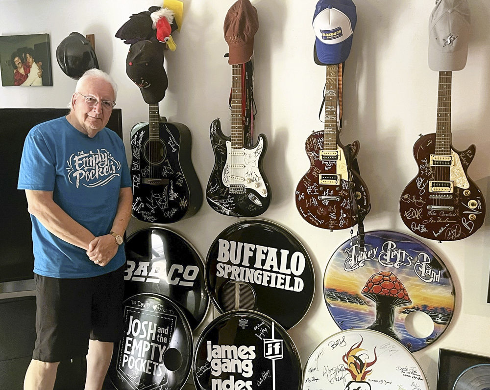 Dave Spero with assorted guitars in his office