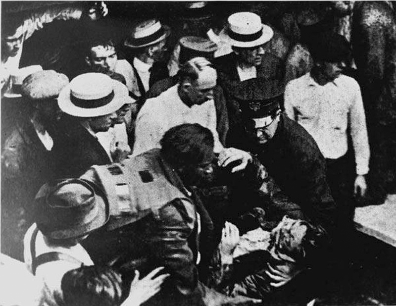 Garrett Morgan helping one of the rescuers that he rescued from the west side waterworks tunnel, ca. 1916