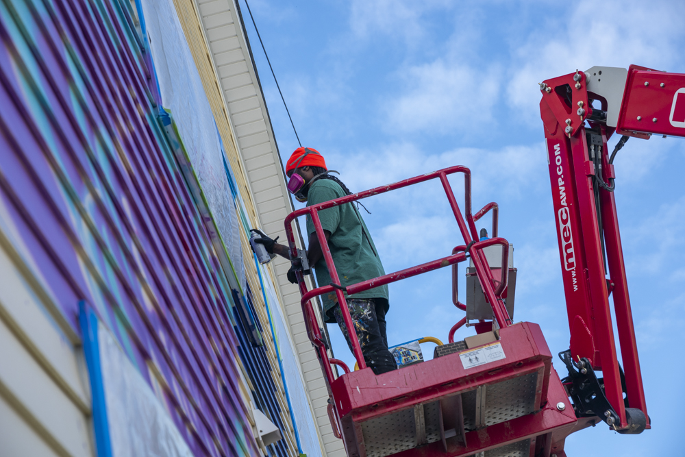 Isaiah Williams working on the Facing History Mural