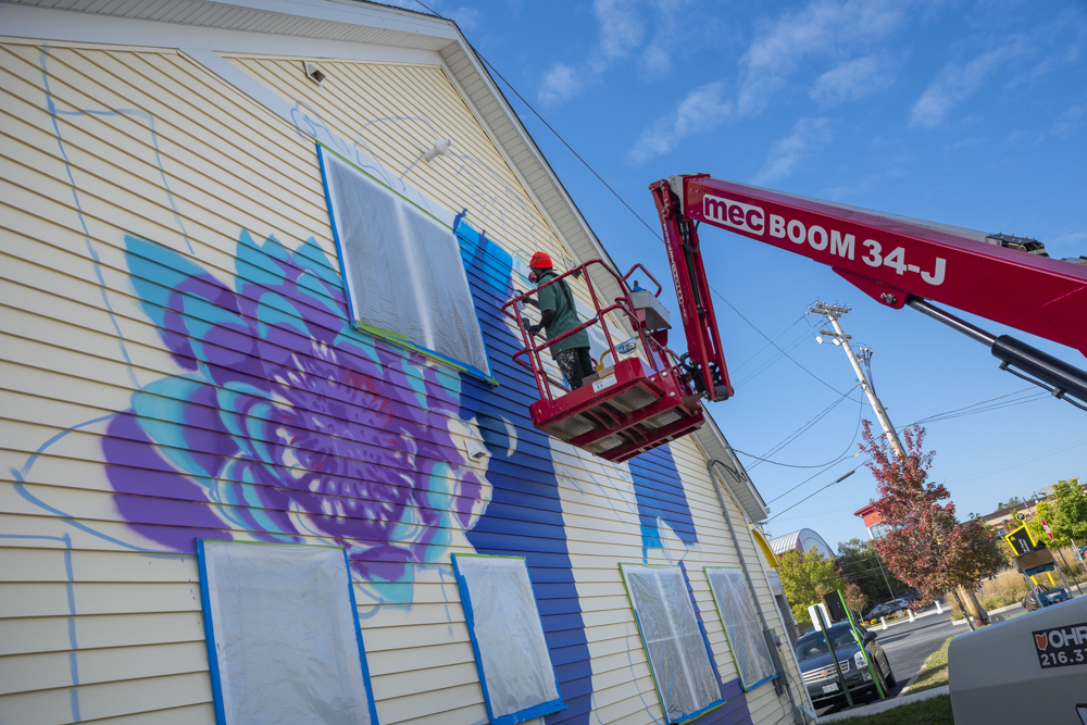 Isaiah Williams working on the Facing History Mural