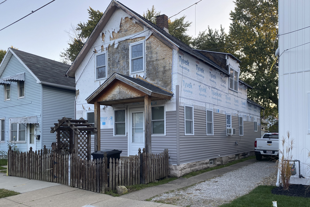 A home in Cleveland’s Clark-Fulton neighborhood in the begining phases of work with funding from a land bank program