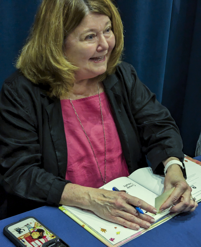 Connie Schultz signs Lola and the Troll books for attendees of her book
reading August 16 at the Cuyahoga County Public Library's Parma-Snow branch