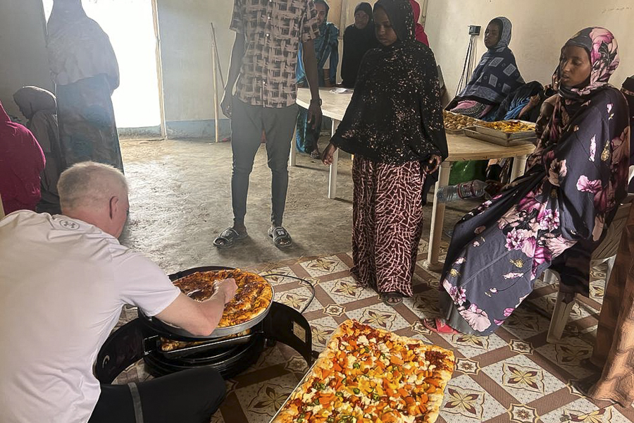Brandon cooking with the villagers in Ali Adde