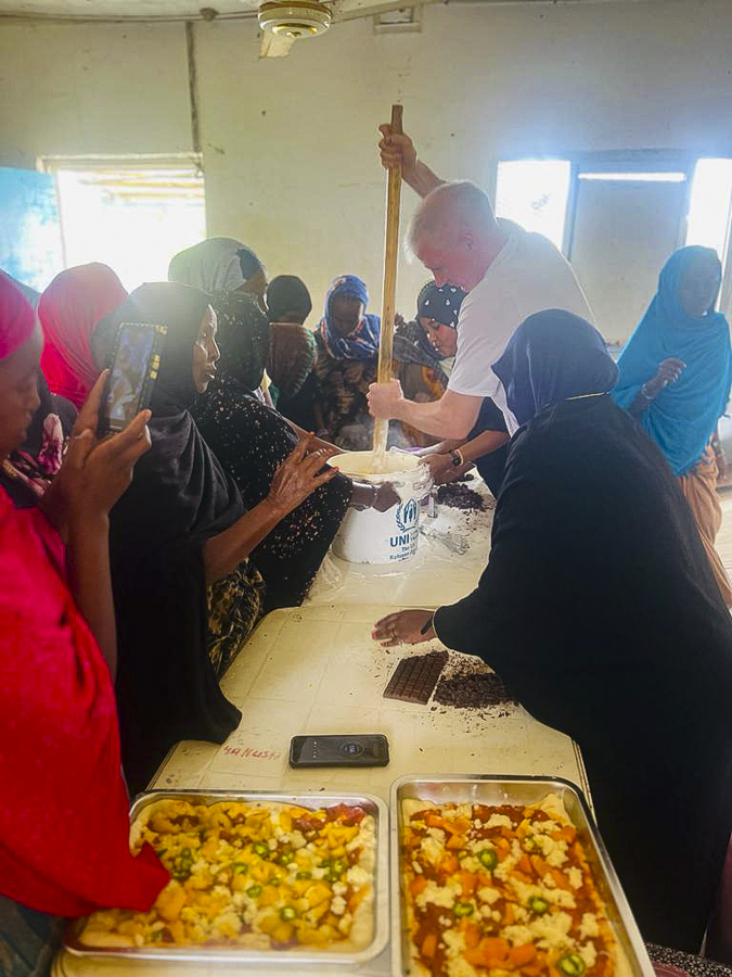 Brandon cooking with the villagers in Ali Adde