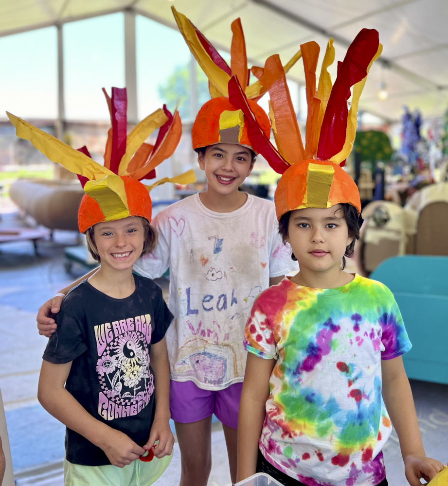 Artists, volunteers, and parade participants putting the final touches on the costumes, puppets, and floats for this year’s Parade the Circle “Visions of Harmony”