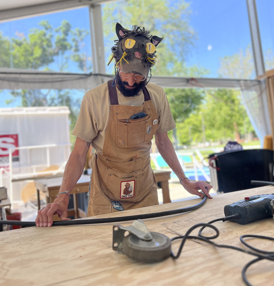 Artists, volunteers, and parade participants putting the final touches on the costumes, puppets, and floats for this year’s Parade the Circle “Visions of Harmony”