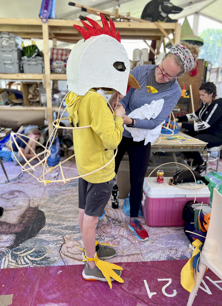 Artists, volunteers, and parade participants putting the final touches on the costumes, puppets, and floats for this year’s Parade the Circle “Visions of Harmony”