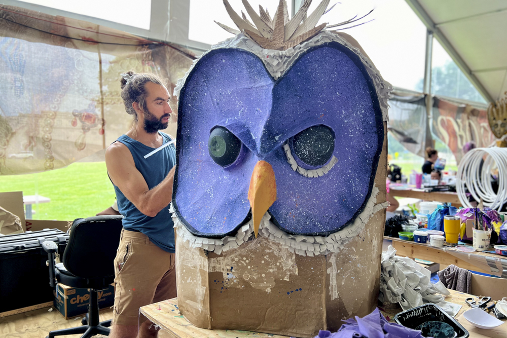 Artists, volunteers, and parade participants putting the final touches on the costumes, puppets, and floats for this year’s Parade the Circle “Visions of Harmony”
