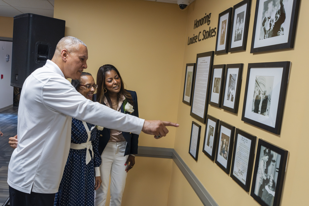 (From left to right) Cordell Stokes, Angela Stokes and Lori Stokes looking at the exhibit honoring their grandmother