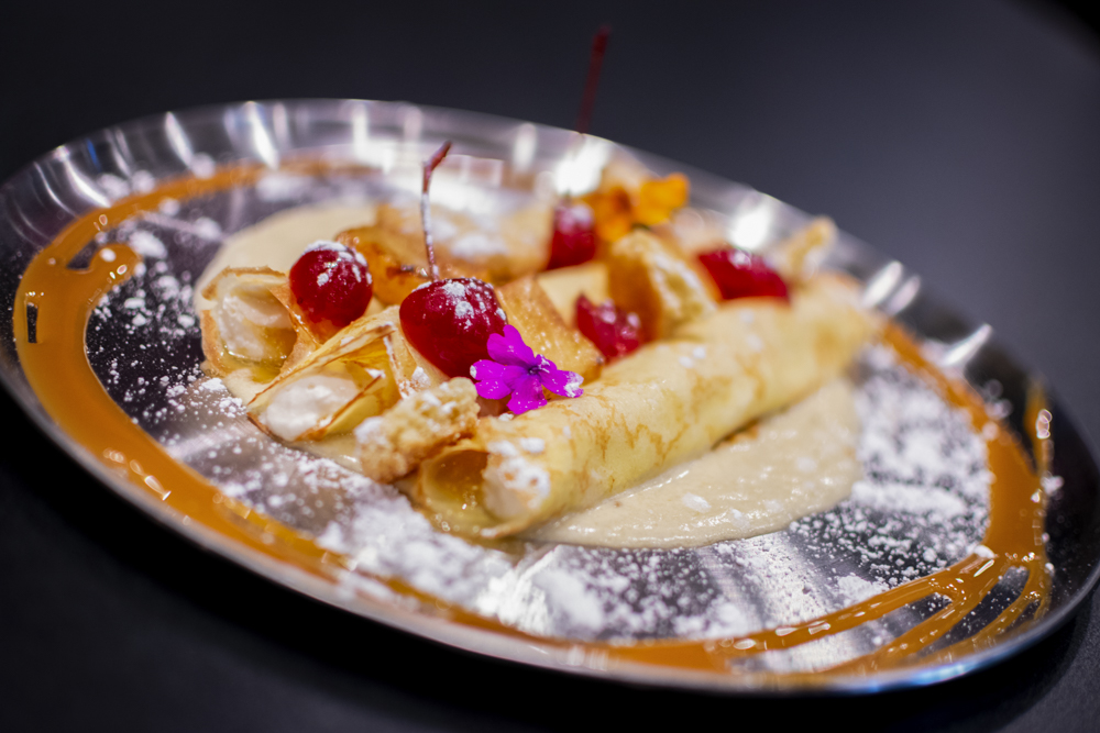 “Upside Down” crepes filled with pineapple kombucha purée and cream cheese on pineapple cream sauce