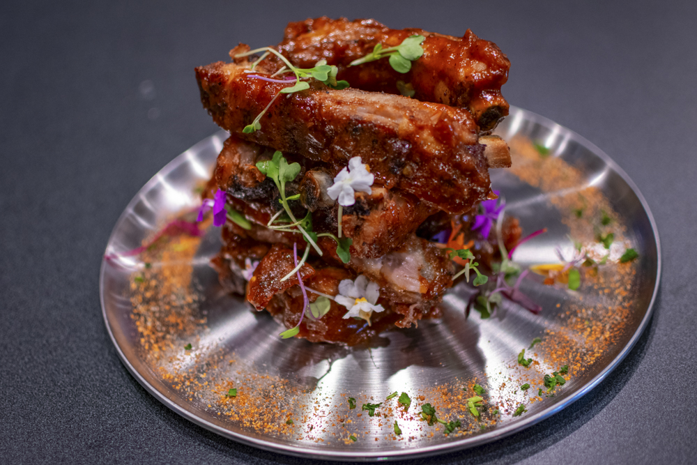 “The Mon-Star” baby back ribes with house-made peach Hennessy BBQ sauce