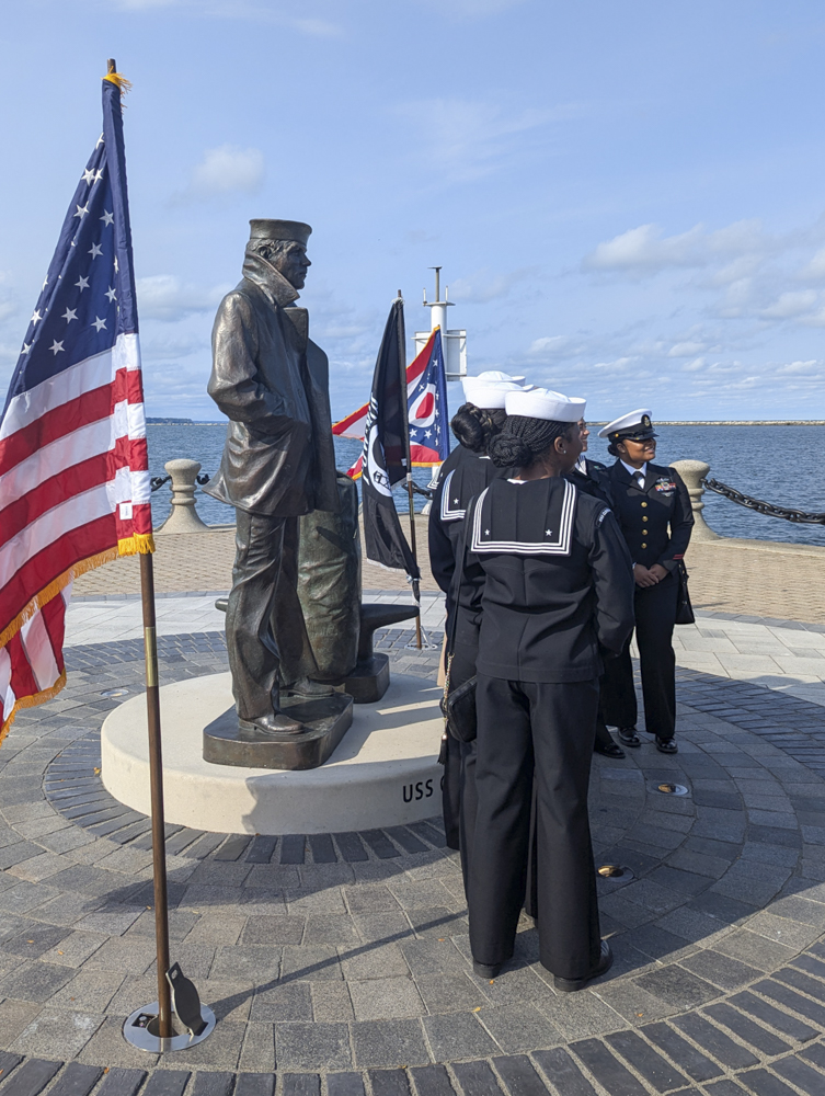 Young sailors who will serve on the USS Cleveland (LCS 31) in 2025 visit the Lone Sailor statue October 12, 2024