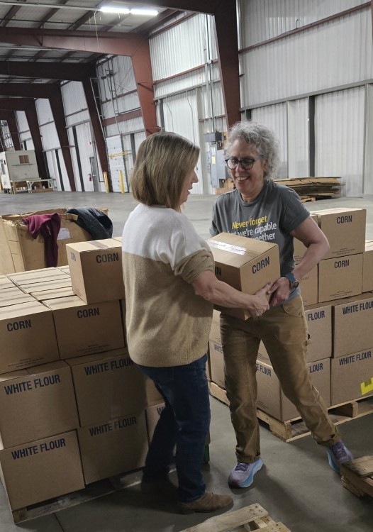Volunteers pack an entire semi-truck with food donations.