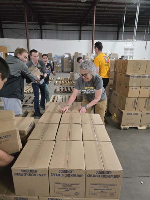 Volunteers sort and pack food donations.