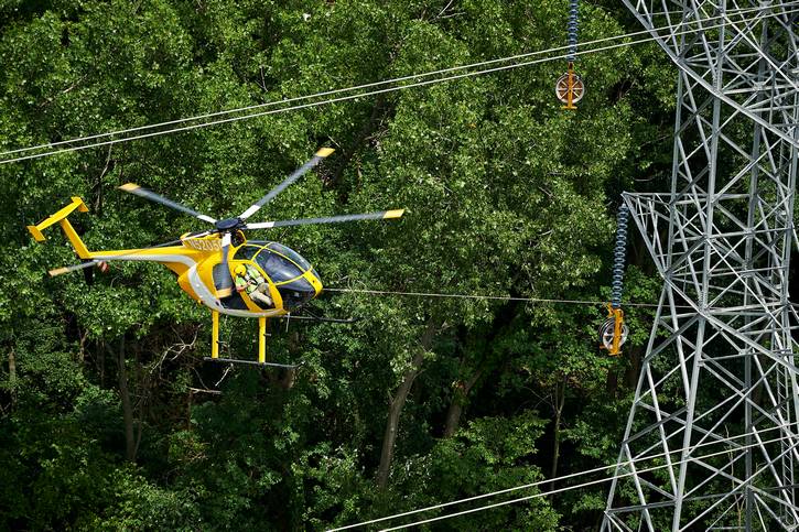 FirstEnergy linemen are dropped onto transmission towers.