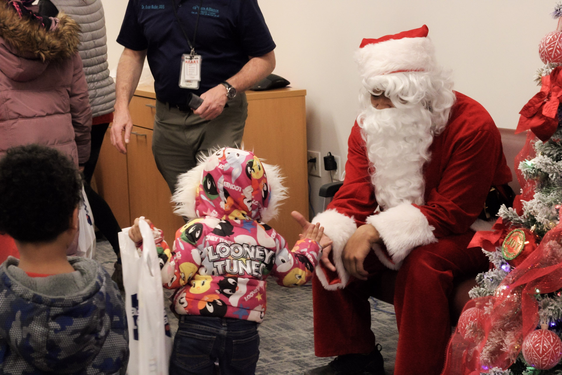 Santa greets and interacts with children during the Holiday Toy Giveback.