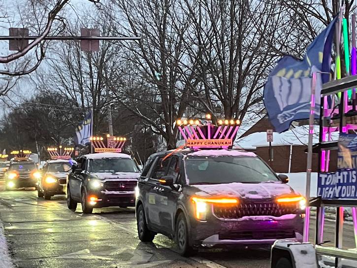 Revelers observed the first night of Chanukah with the Light After Dark Menorah Parade.