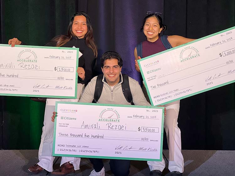 AISA co-founder Amirali Rezaei with his three awards checks