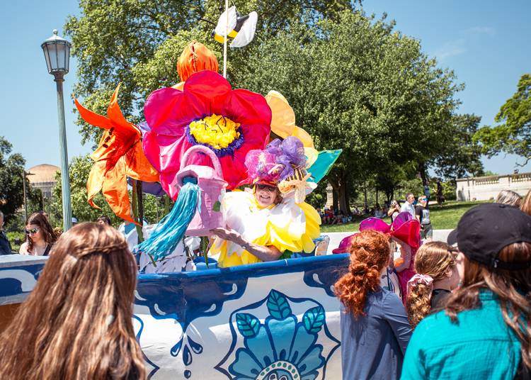 A flower with a watering can on this flower ensemble.