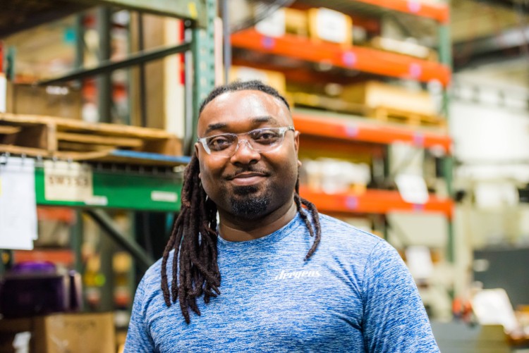 Jergens employee teaches shows students the manufacturing ropes.