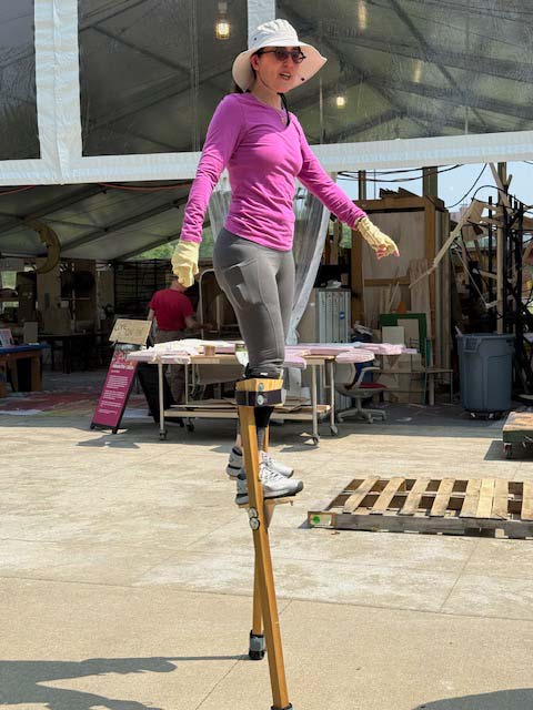 Professional stilt walker Heather Schloss practices for Parade the Circle.