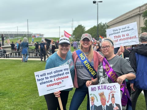Brady Dindia, right, marches with her friends from ARTFUL Cleveland