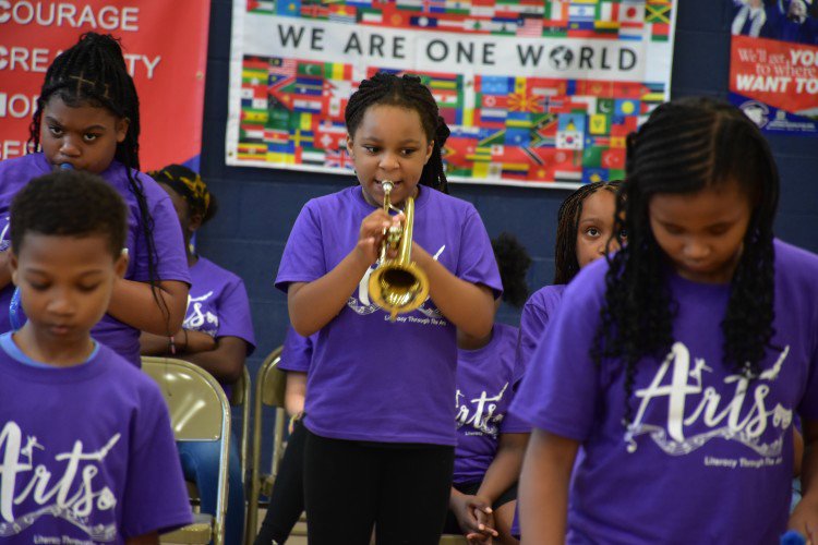 Learning to play instruments at Literacy Through the Arts Summer Academy