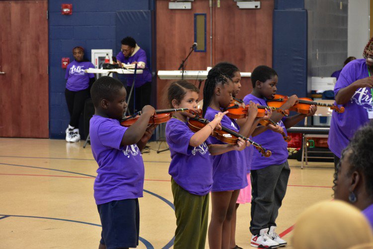 Learning to play instruments at Literacy Through the Arts Summer Academy