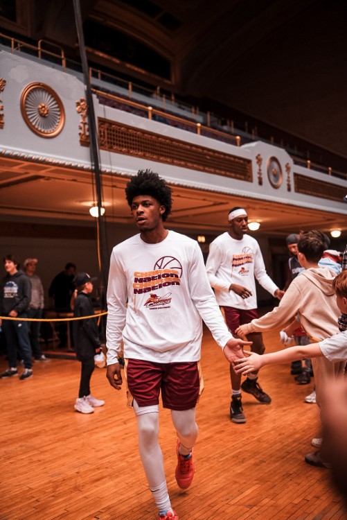 The graphic design team greets Charge guard London Johnson & forward Nae'Qwan Tomlin