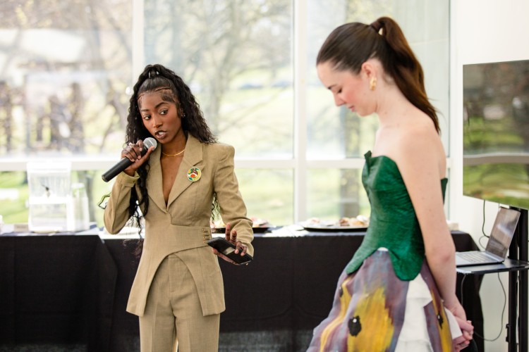 A KSU fashion design student presents a Salvador Dali-inspired garment to the panel of judges.