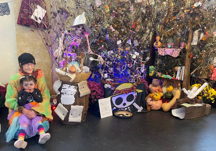 Lori Lane and Sylvia, sitting with the ofrenda that Lori designed.