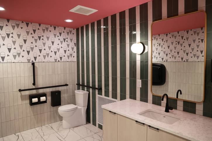 The new top-of-the-line bathrooms feature a classy but playful aesthetic, including ice cream cone wallpaper.