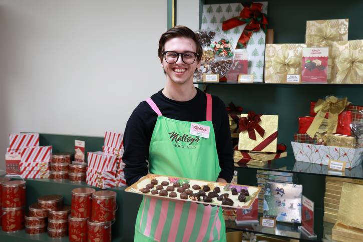 A Malley's employee welcomes customers.