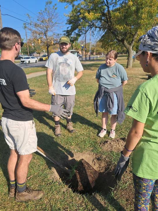 OBCDC Tree Stewards demonstrate how to properly plant trees to residents at Estabrook Rec Center.