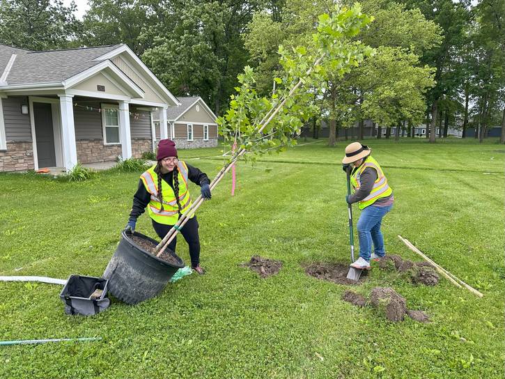 West Park Kamm’s Neighborhood Development Tree Stewards prepare to plant a tree at CMHA Riverside.