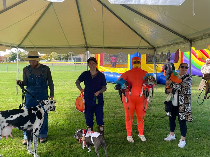 Guests and dogs await the announcement of the pet costume contest winner.
