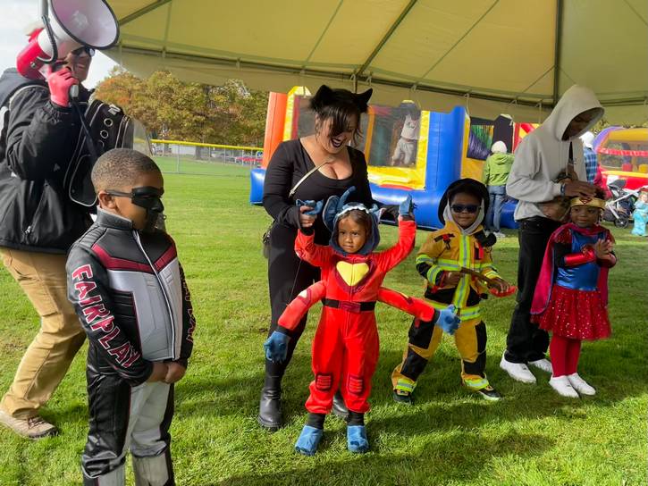 Youngsters line up to show off their costumes in the costume contest, competing for a family prize of $250.