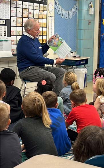 Author Dave Grunenwald reads his book to a group of children.