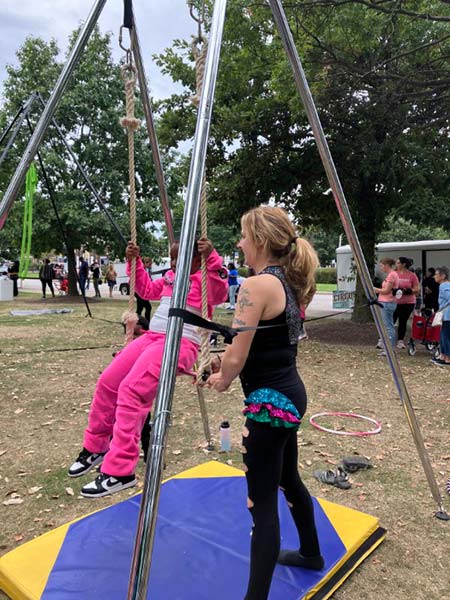 A Sky Circus Cleveland aerialist demonstrates how to use a trapeze.