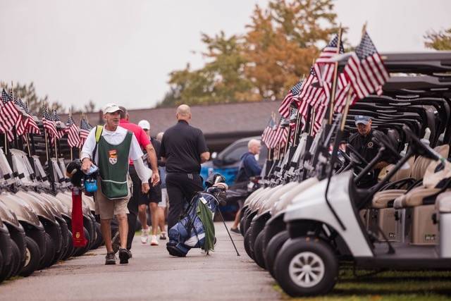 Golf carts lined up flying American flags during the VFR Foundation's 4th Annual Golf Outing  and fundraiser.