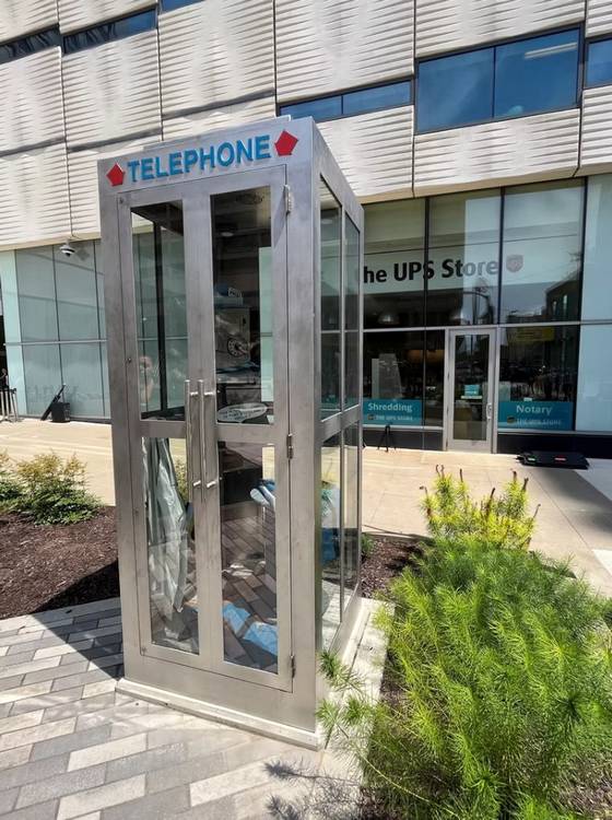 The nine-foot-high enclosed phone booth made of fabricated steel at Superman Plaza.